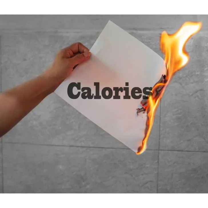 A person holding a piece of paper with the word calories on it, burning, burning calories